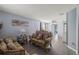 Comfortable living room featuring grey wood floors, light blue walls, an ornate sofa, and decor at 2318 Kenwick Dr, Valrico, FL 33596