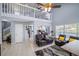 Bright living room featuring a high ceiling, ceiling fan, leather furniture, and a view to the kitchen at 2318 Kenwick Dr, Valrico, FL 33596