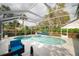 Relaxing screened-in pool and hot tub area with patio seating, perfect for outdoor enjoyment at 2318 Kenwick Dr, Valrico, FL 33596