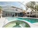 Relax in this screened pool with a hot tub and ample space for lounging at 2318 Kenwick Dr, Valrico, FL 33596