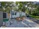 The backyard features a white picket fence, a green shed, and a sitting area at 284 North St, Palm Harbor, FL 34683