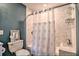 Bathroom with white tile and modern patterned shower curtain in a tub/shower combo at 284 North St, Palm Harbor, FL 34683