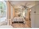 Cozy bedroom with light wood floors, comfortable bed and modern mini-split AC unit at 284 North St, Palm Harbor, FL 34683