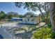 A lovely home with a manicured lawn, mature trees and a picket fence provides nice curb appeal at 284 North St, Palm Harbor, FL 34683