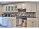 Well-equipped kitchen with white cabinets, stainless steel appliances, and modern countertop at 284 North St, Palm Harbor, FL 34683