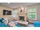 Cozy living room boasting a brick fireplace, bright windows, and modern TV at 284 North St, Palm Harbor, FL 34683