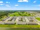 Expansive aerial view showcasing a planned community near a lake and highway at 2925 Evergreen Elm Pass, Wesley Chapel, FL 33543