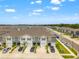 Aerial view of modern townhomes with well-manicured landscaping and ample parking at 2925 Evergreen Elm Pass, Wesley Chapel, FL 33543