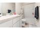 Clean bathroom featuring a single sink vanity and a shower with a decorative curtain at 2925 Evergreen Elm Pass, Wesley Chapel, FL 33543