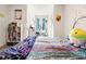 Bright bedroom with desk and bed areas, decorated with a large bookshelf at 2925 Evergreen Elm Pass, Wesley Chapel, FL 33543