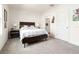 Cozy bedroom with a large window, wood-trimmed bed, and ensuite bathroom access at 2925 Evergreen Elm Pass, Wesley Chapel, FL 33543