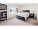 Bright bedroom featuring a comfortable bed, a view of the outside, and decorative touches at 2925 Evergreen Elm Pass, Wesley Chapel, FL 33543