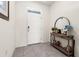 Bright foyer with tile flooring, console table, mirror, and decor at 2925 Evergreen Elm Pass, Wesley Chapel, FL 33543