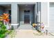 Inviting front entrance with a black door and decorative landscaping at 2925 Evergreen Elm Pass, Wesley Chapel, FL 33543