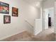 Upstairs hallway with carpet flooring and decorated with movie posters at 2925 Evergreen Elm Pass, Wesley Chapel, FL 33543