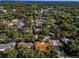 A broad, high-altitude view of the neighborhood with numerous trees and diverse houses at 3041 Oak View Dr, Palm Harbor, FL 34684