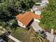 Aerial view of the home showcasing its roof, landscaping, and unique concrete driveway at 3041 Oak View Dr, Palm Harbor, FL 34684