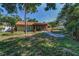 Backyard view of the home, landscaping, and outdoor living space at 3041 Oak View Dr, Palm Harbor, FL 34684