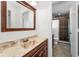 Bathroom featuring a wood-framed mirror and vanity with a tile shower at 3041 Oak View Dr, Palm Harbor, FL 34684