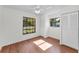 Bedroom with wood floors, large windows, and closet space at 3041 Oak View Dr, Palm Harbor, FL 34684