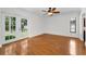 Bright bedroom features wood floors and a door leading to the yard at 3041 Oak View Dr, Palm Harbor, FL 34684