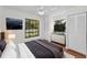 Staged bedroom with a large window and ceiling fan at 3041 Oak View Dr, Palm Harbor, FL 34684