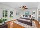 Bright bedroom features wood floors, a gray bed, and a door leading to the yard at 3041 Oak View Dr, Palm Harbor, FL 34684