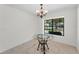 Bright dining area with glass table, chandelier, and tiled floors at 3041 Oak View Dr, Palm Harbor, FL 34684
