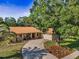 Charming single-story home with a well-manicured front yard and a welcoming, curving driveway at 3041 Oak View Dr, Palm Harbor, FL 34684