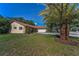 Exterior front view of the home, landscaping, and front yard at 3041 Oak View Dr, Palm Harbor, FL 34684