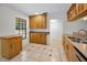 Kitchen area with abundant maple cabinets, stainless dishwasher, and exterior window at 3041 Oak View Dr, Palm Harbor, FL 34684