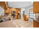 Modern kitchen with stainless steel appliances, granite countertops, wooden cabinetry, and a view of the backyard at 3041 Oak View Dr, Palm Harbor, FL 34684