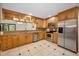 Well lit eat-in kitchen with stainless steel appliances and plentiful maple-colored cabinets at 3041 Oak View Dr, Palm Harbor, FL 34684