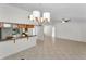 Open-concept living area with tiled floor and pass-through to eat-in kitchen at 3041 Oak View Dr, Palm Harbor, FL 34684