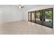 Living room with tiled floors and view of screened in porch at 3041 Oak View Dr, Palm Harbor, FL 34684