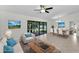 Staged open concept living and dining area with tiled floors and access to the lanai at 3041 Oak View Dr, Palm Harbor, FL 34684