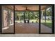 Screened-in patio with tile flooring, ceiling fan, and backyard view at 3041 Oak View Dr, Palm Harbor, FL 34684