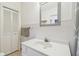 Simple bathroom with a single sink, white cabinets and tiles, and classic fixtures at 3105 W San Isidro St, Tampa, FL 33629