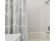 Clean bathroom featuring a tub with white tile surround and a shower curtain at 3105 W San Isidro St, Tampa, FL 33629