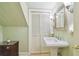 A charming bathroom featuring a pedestal sink and classic fixtures at 3105 W San Isidro St, Tampa, FL 33629