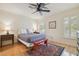 Comfortable bedroom with hardwood floors, ceiling fan, window shutters, and a colorful rug at 3105 W San Isidro St, Tampa, FL 33629