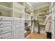Custom closet with built-in shelving, drawers, and hardwood floors for organized storage at 3105 W San Isidro St, Tampa, FL 33629