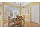 Bright dining room with a round table set for four, bathed in natural light at 3105 W San Isidro St, Tampa, FL 33629