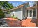 Charming backyard patio with brick flooring and a quaint white picket fence at 3105 W San Isidro St, Tampa, FL 33629