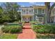 Charming two-story home with a red brick walkway, balcony, and manicured landscaping at 3105 W San Isidro St, Tampa, FL 33629