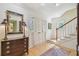 Entryway featuring hardwood floors, staircase, and decorative mirror on dresser at 3105 W San Isidro St, Tampa, FL 33629