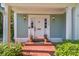 Inviting front door with sidelights and potted plants and a brick walkway at 3105 W San Isidro St, Tampa, FL 33629
