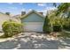 A two-car garage with lush greenery in the front yard adds to the property's curb appeal at 3105 W San Isidro St, Tampa, FL 33629
