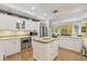 Spacious kitchen with stainless steel appliances, center island, and hardwood floors at 3105 W San Isidro St, Tampa, FL 33629