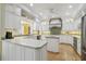 Bright kitchen features custom white cabinetry, an island, and stainless steel appliances at 3105 W San Isidro St, Tampa, FL 33629